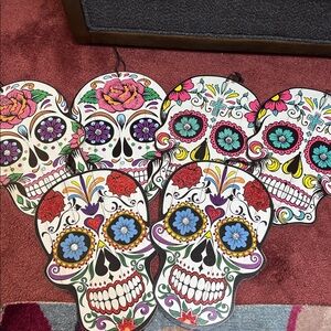 Colorful Day of the Dead Wooden Skulls with clear round decorative eyes.